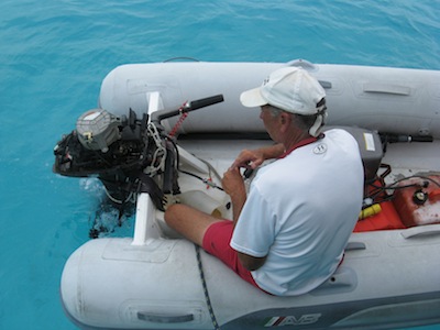 David working on our trusty Tohatsu in the Exumas. Whew, close call!