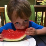 Rowan, our oldest grandson, munching some summer watermelon.
